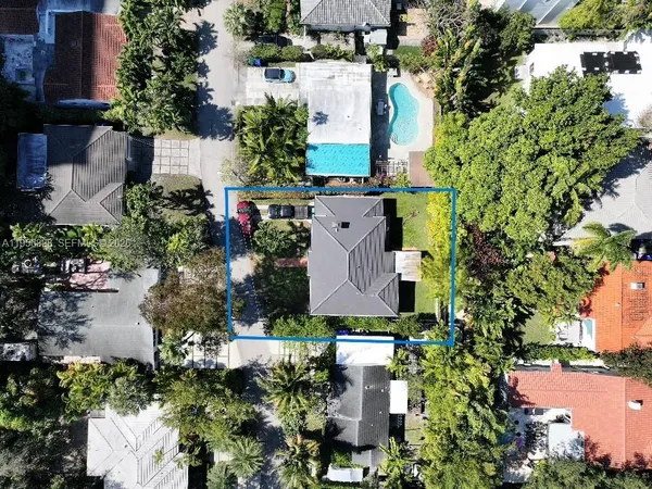 an aerial view of a house with a yard and lake view