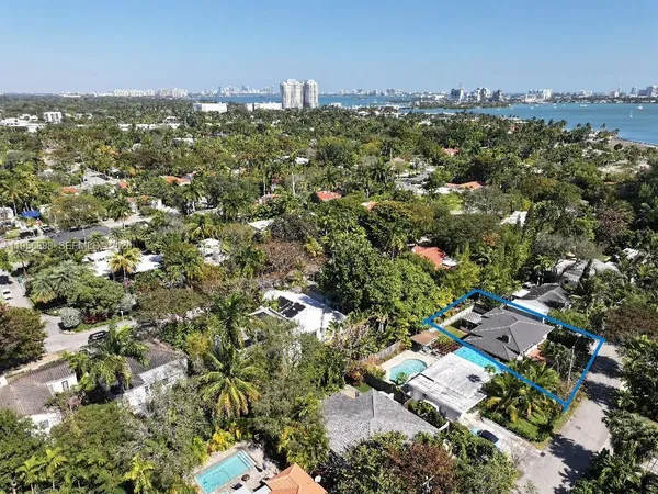 an aerial view of residential houses with city view
