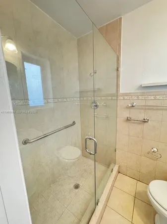 a bathroom with a shower and toilet