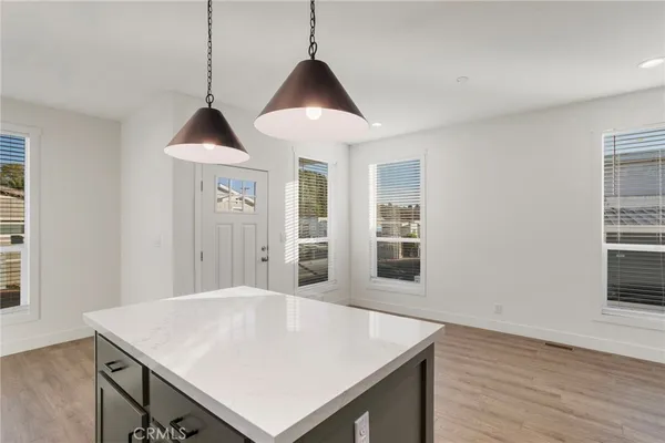 a view of kitchen island with wooden floor and sink