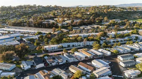 an aerial view of residential houses with city view