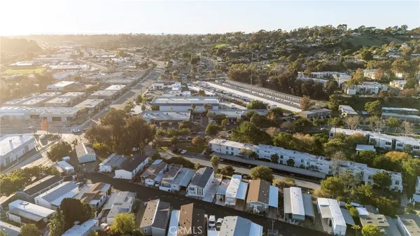 an aerial view of residential houses with city view