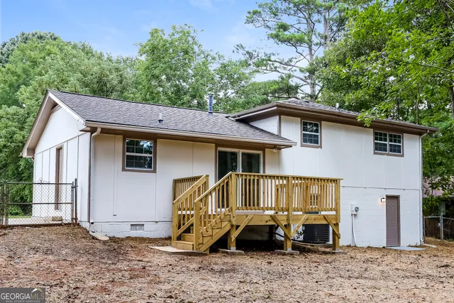 a view of a house with a yard and sitting area