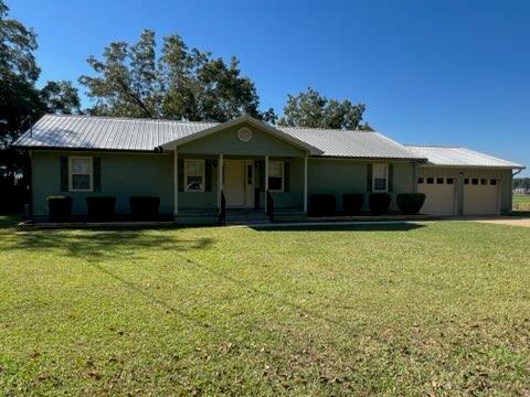 60 Strawberry Road Pineview, GA 31071 - Photo 1 of 1 a front view of a house with a garden