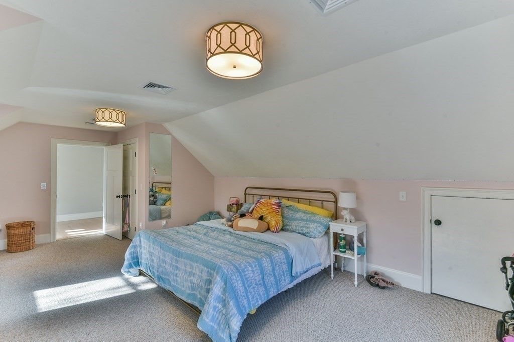 15 Lakeview Road Webster, MA 01570 - Photo 22 of 42 a bedroom with a bed and a chandelier