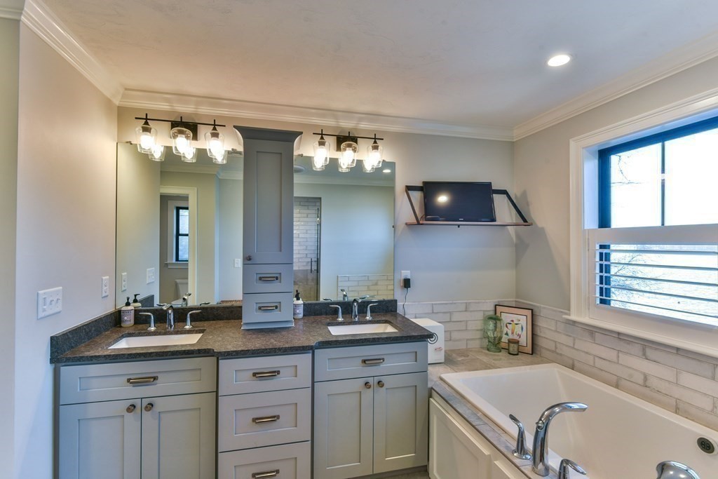 15 Lakeview Road Webster, MA 01570 - Photo 31 of 42 a bathroom with a granite countertop sink a large mirror and a bathtub