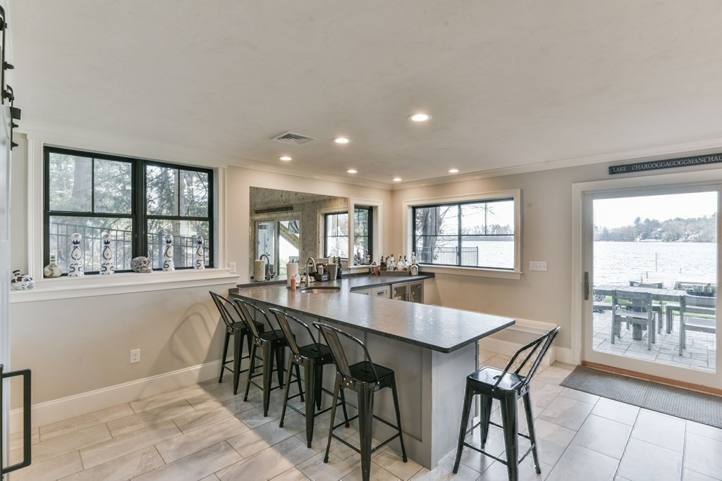 15 Lakeview Road Webster, MA 01570 - Photo 34 of 42 a dining room with stainless steel appliances granite countertop a table and chairs with wooden floor