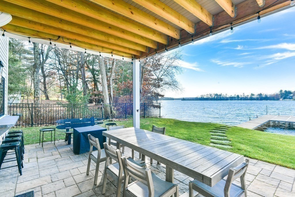 15 Lakeview Road Webster, MA 01570 - Photo 40 of 42 a view of a patio with a table chairs and a backyard