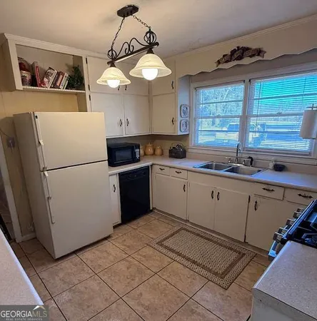 a kitchen with a sink a refrigerator and window