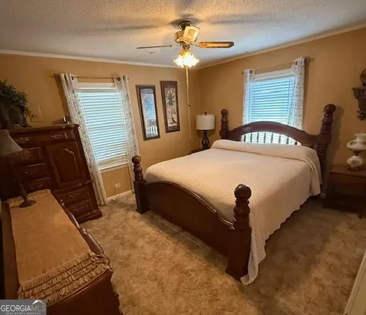 a bed sitting in a bedroom next to a window