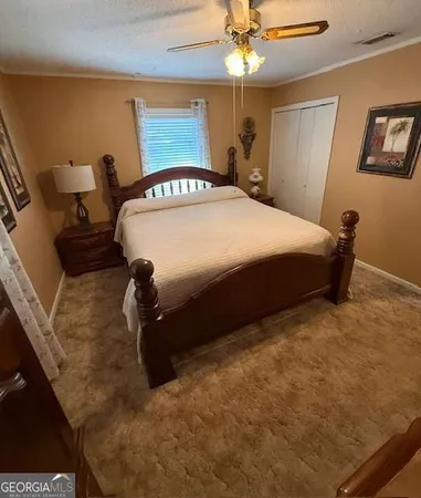 a bedroom with a bed and ceiling fan