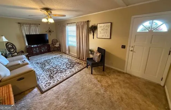 a living room with furniture and a flat screen tv