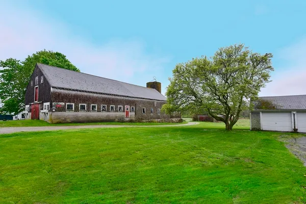 a front view of house with yard and green space