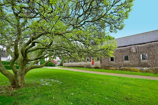 a view of house with a backyard