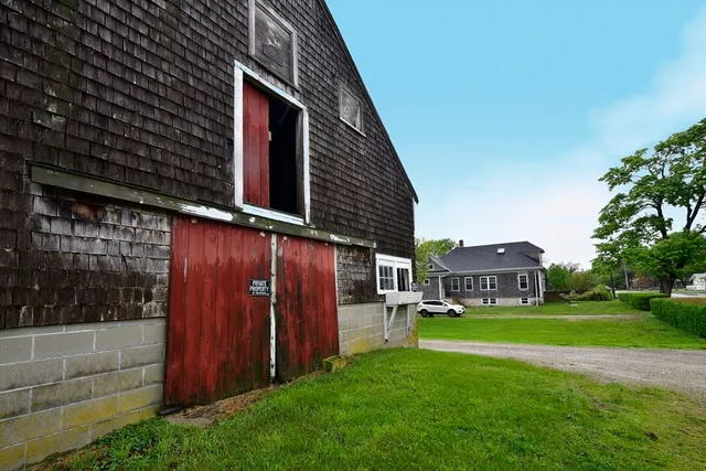 a living room with furniture a flat screen tv and a window