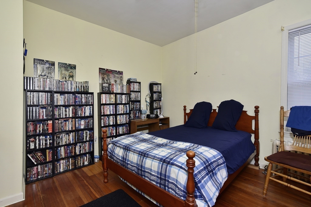 482 Smith Neck Road Dartmouth, MA 02748 - Photo 33 of 40 a bedroom with a bed and a book shelf