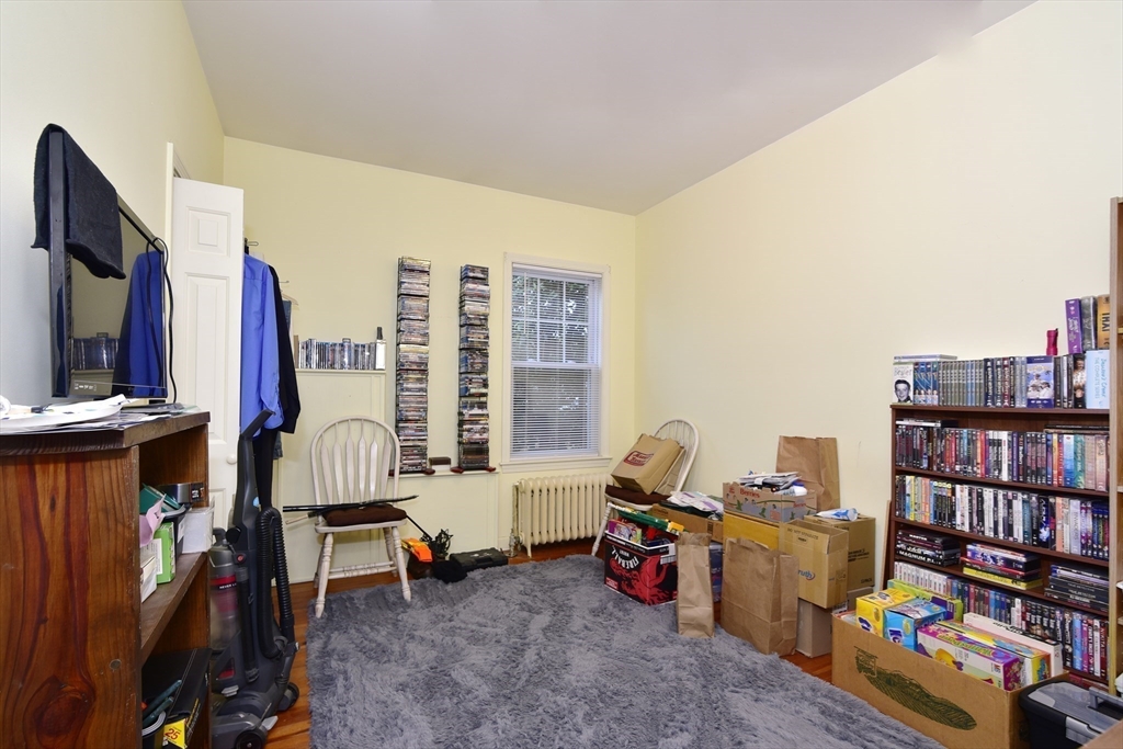 482 Smith Neck Road Dartmouth, MA 02748 - Photo 34 of 40 a living room with furniture a bookshelf and a window