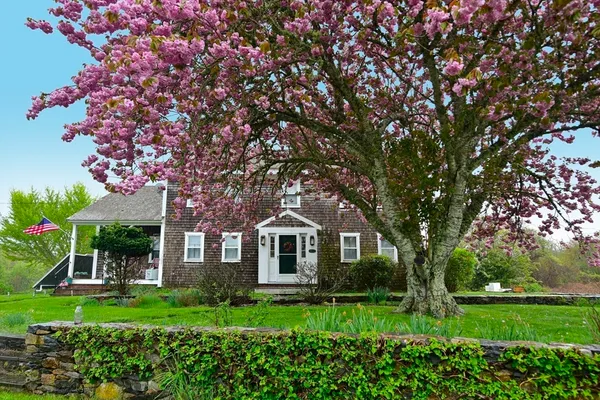 a front view of a house with a yard