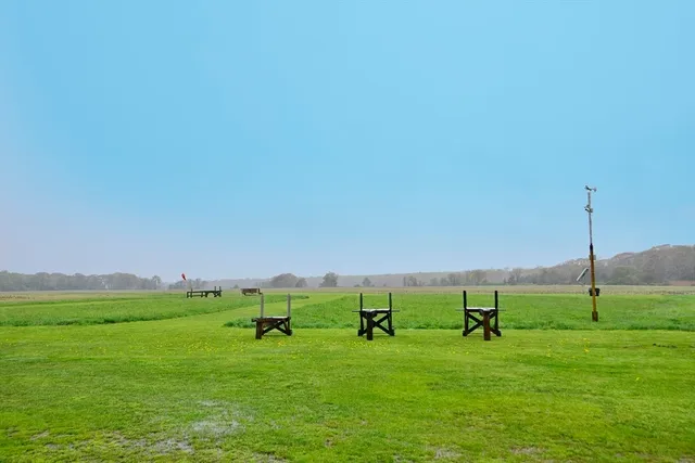 a view of a field with an ocean
