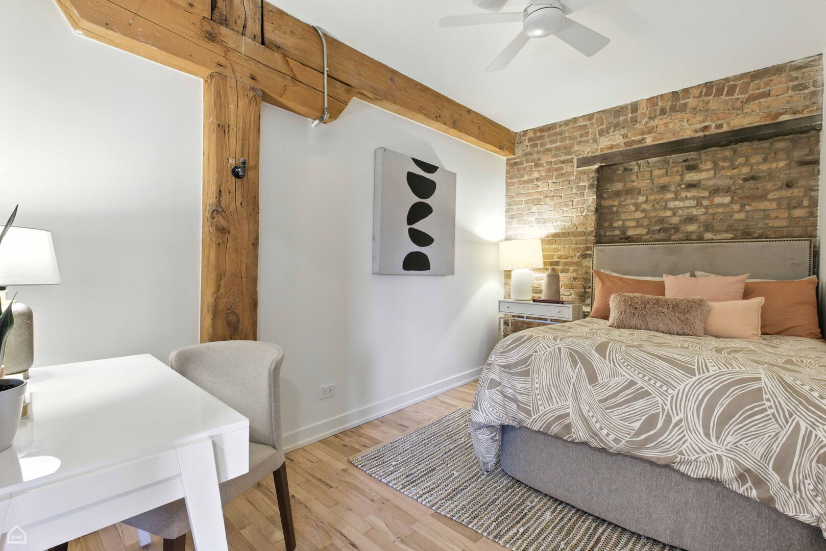 515 North Noble Street, Unit 308 Chicago, IL 60642 - Photo 11 of 13 a bedroom with a bed and a table in it