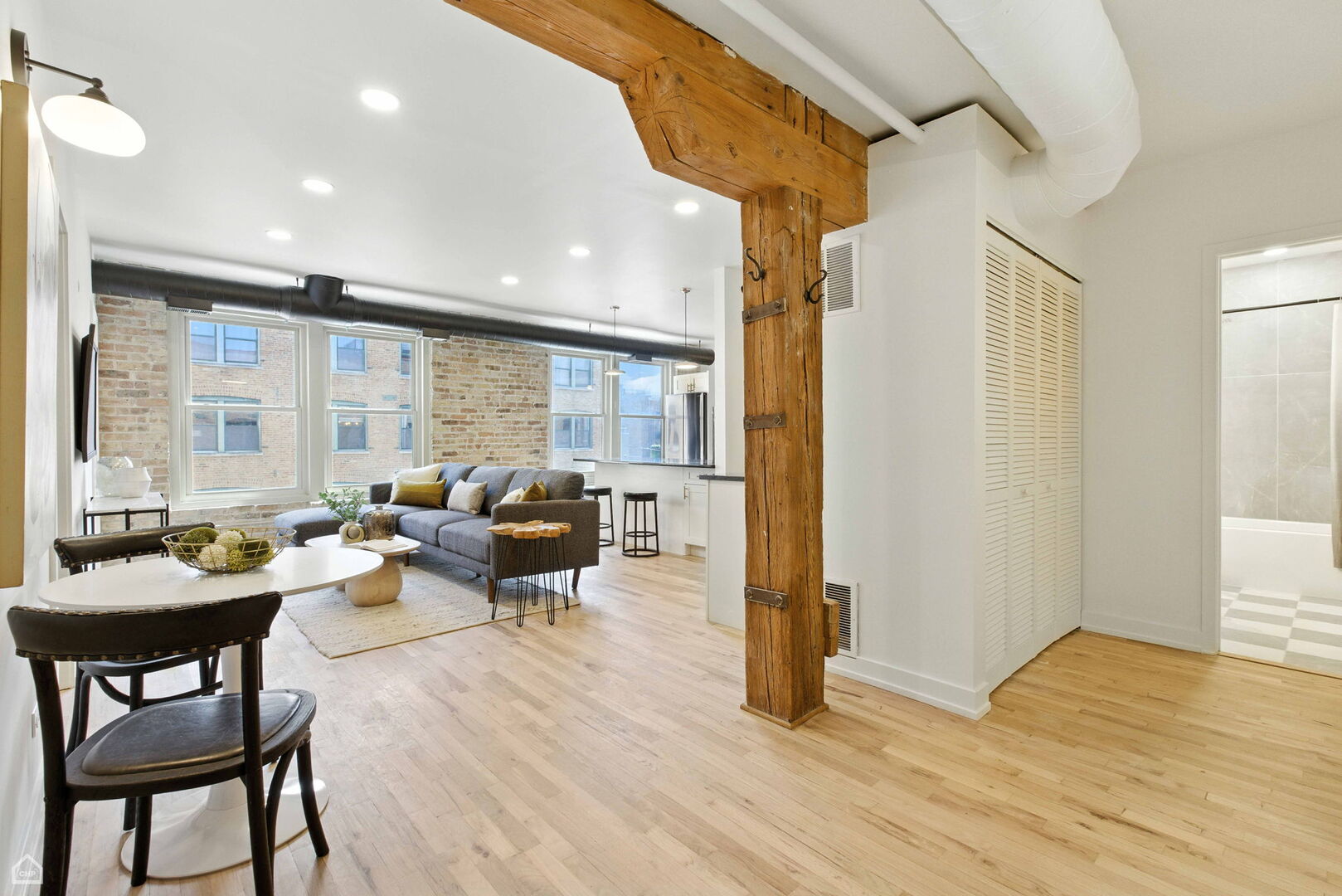 515 North Noble Street, Unit 308 Chicago, IL 60642 - Photo 12 of 13 a living room with furniture and a large window