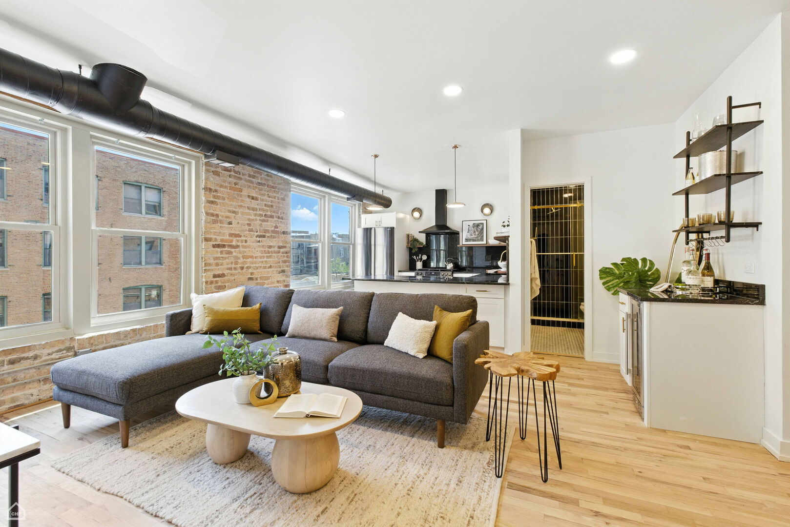 515 North Noble Street, Unit 308 Chicago, IL 60642 - Photo 2 of 13 a living room with furniture and a table