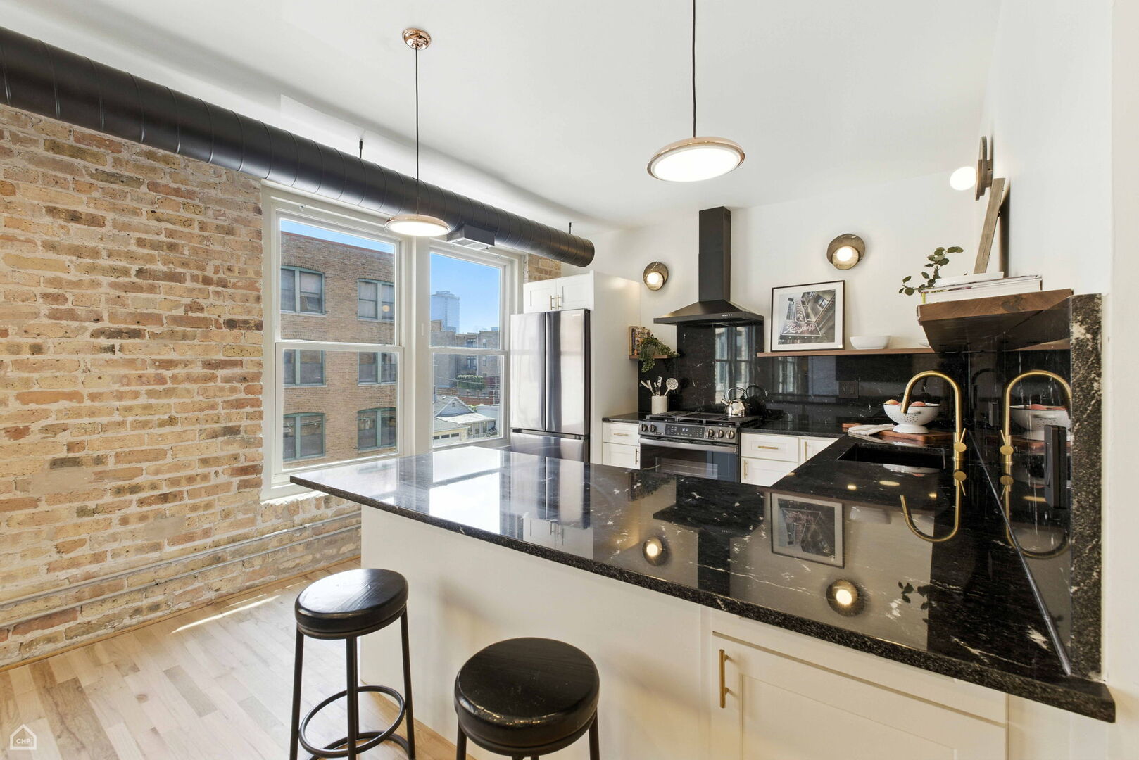 515 North Noble Street, Unit 308 Chicago, IL 60642 - Photo 5 of 13 a kitchen with stainless steel appliances a sink a counter space and cabinets