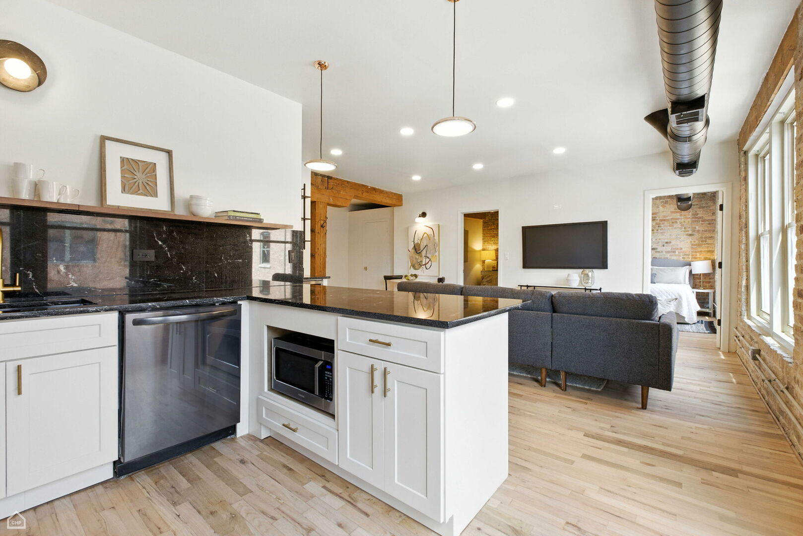 515 North Noble Street, Unit 308 Chicago, IL 60642 - Photo 6 of 13 a kitchen with stainless steel appliances granite countertop a stove top oven a sink dishwasher a dining table and chairs with wooden floor