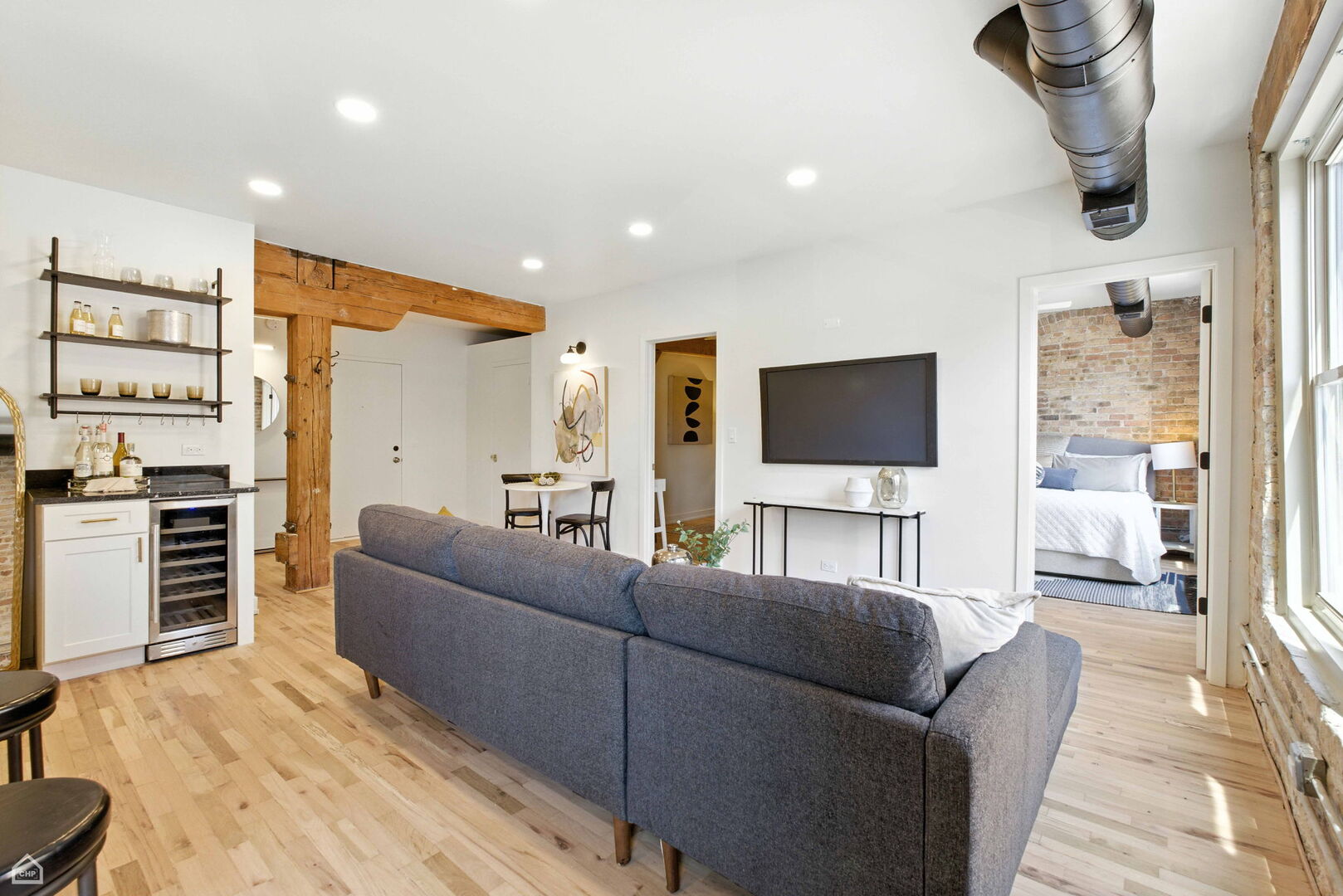 515 North Noble Street, Unit 308 Chicago, IL 60642 - Photo 7 of 13 a living room with furniture and a flat screen tv