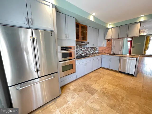 a kitchen with stainless steel appliances a refrigerator and stove