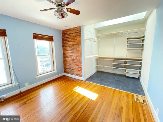 a view of room with window and wooden floor