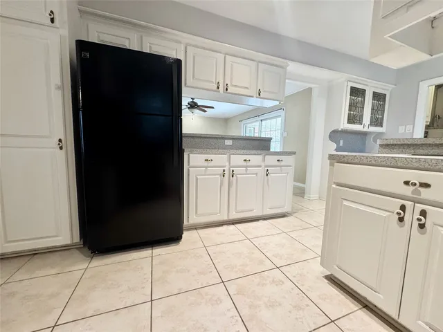 a kitchen with a refrigerator a stove and cabinets