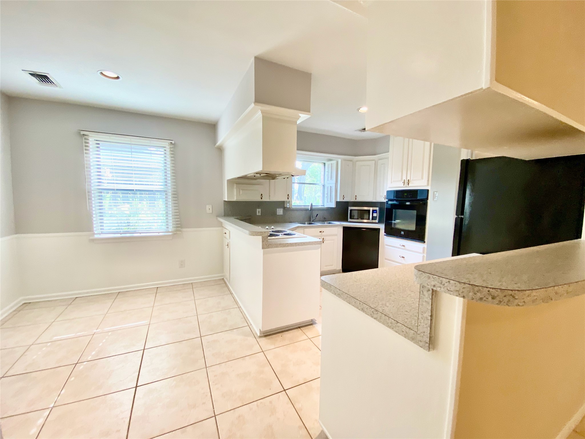2206 Tannehill Drive Houston, TX 77008 - Photo 19 of 42 a kitchen with stainless steel appliances a refrigerator sink and microwave