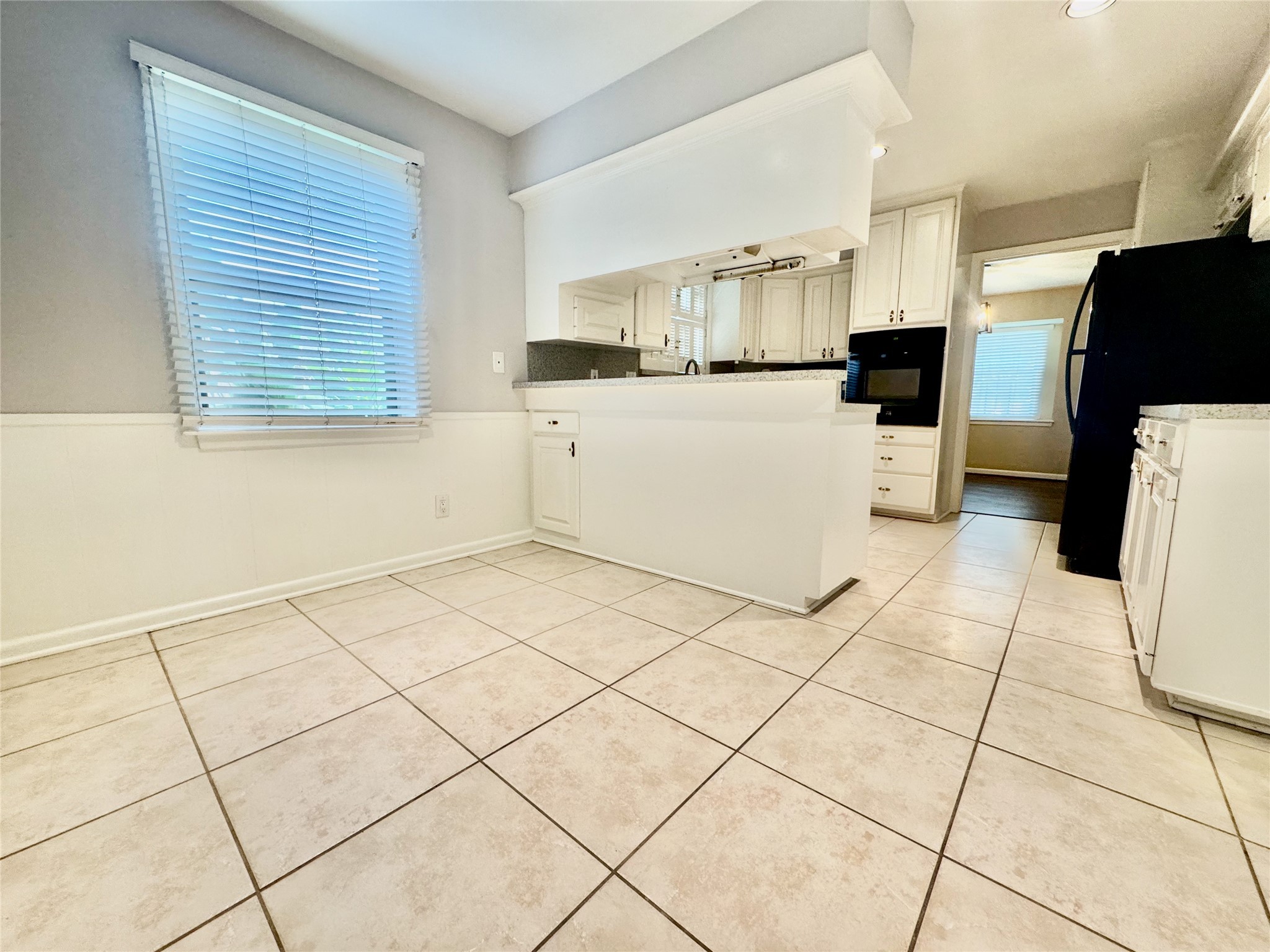 2206 Tannehill Drive Houston, TX 77008 - Photo 20 of 42 a kitchen with cabinets and white appliances