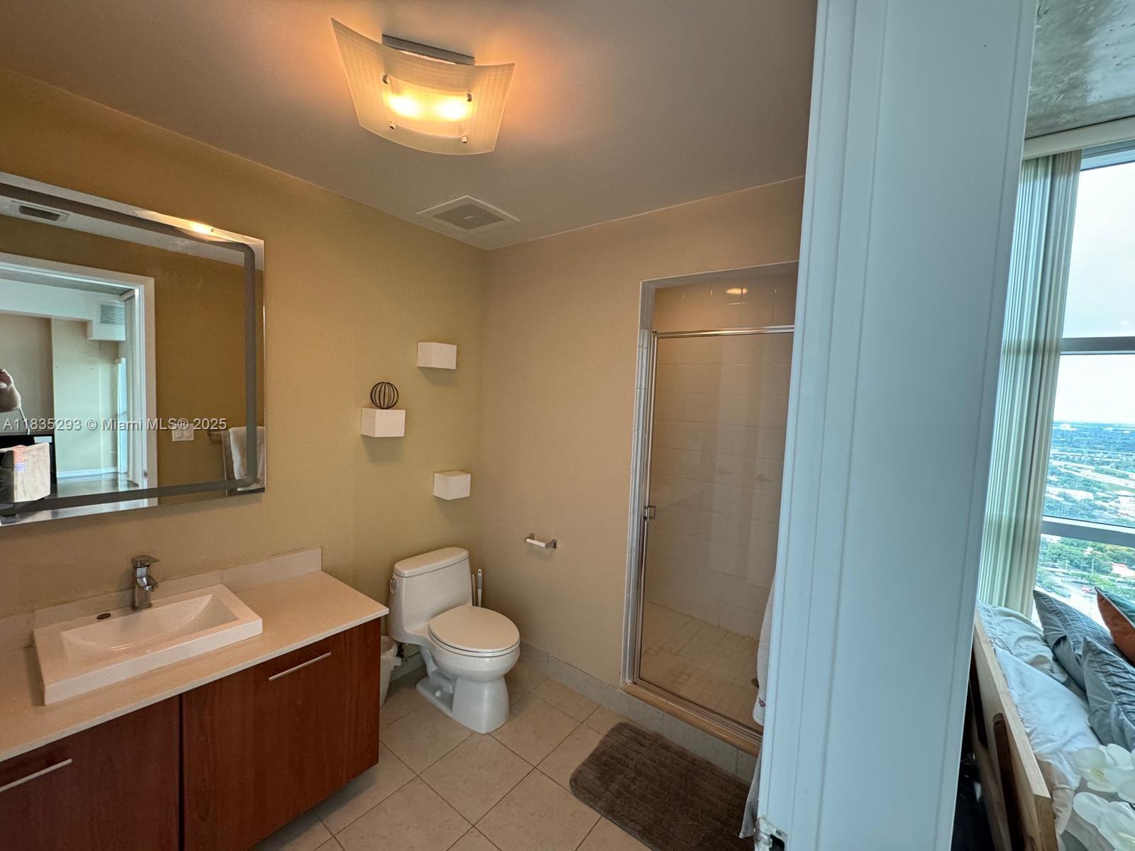 3301 Northeast 1st Avenue, Unit H2903 Miami, FL 33137 - Photo 14 of 20 a bathroom with a toilet sink and a mirror