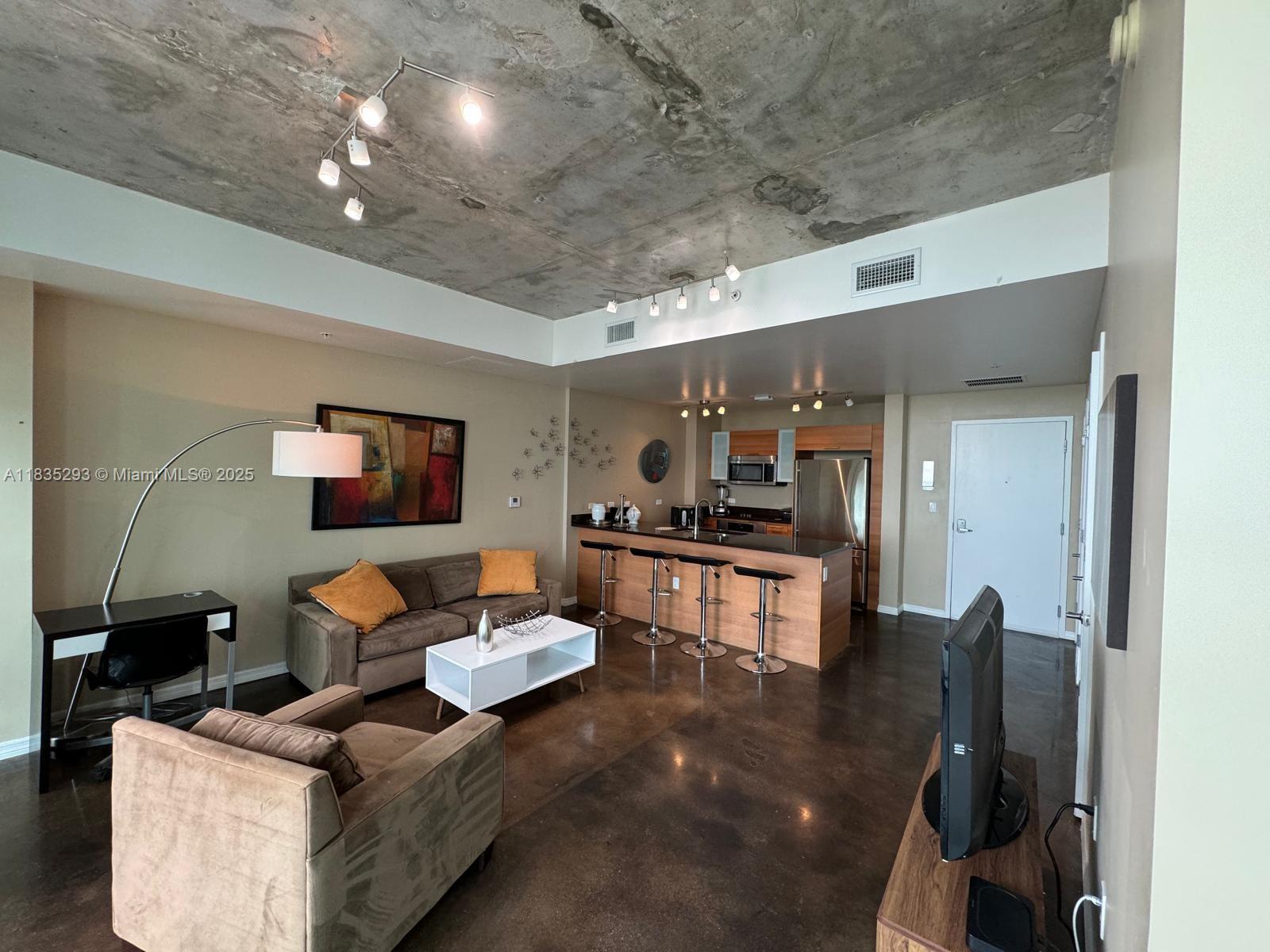 3301 Northeast 1st Avenue, Unit H2903 Miami, FL 33137 - Photo 2 of 20 a living room with furniture and a flat screen tv