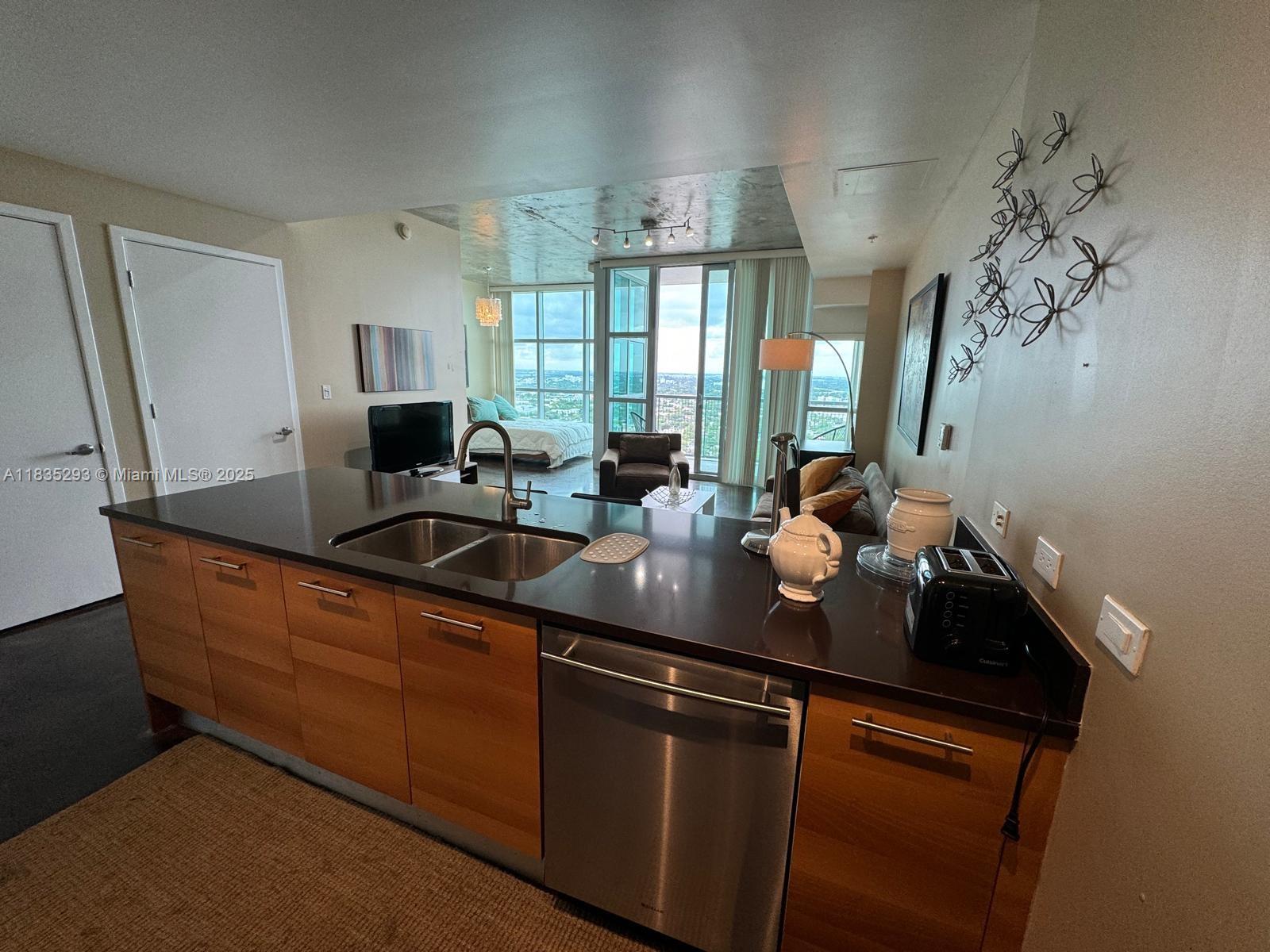 3301 Northeast 1st Avenue, Unit H2903 Miami, FL 33137 - Photo 3 of 20 a kitchen with stainless steel appliances a sink a window and cabinets