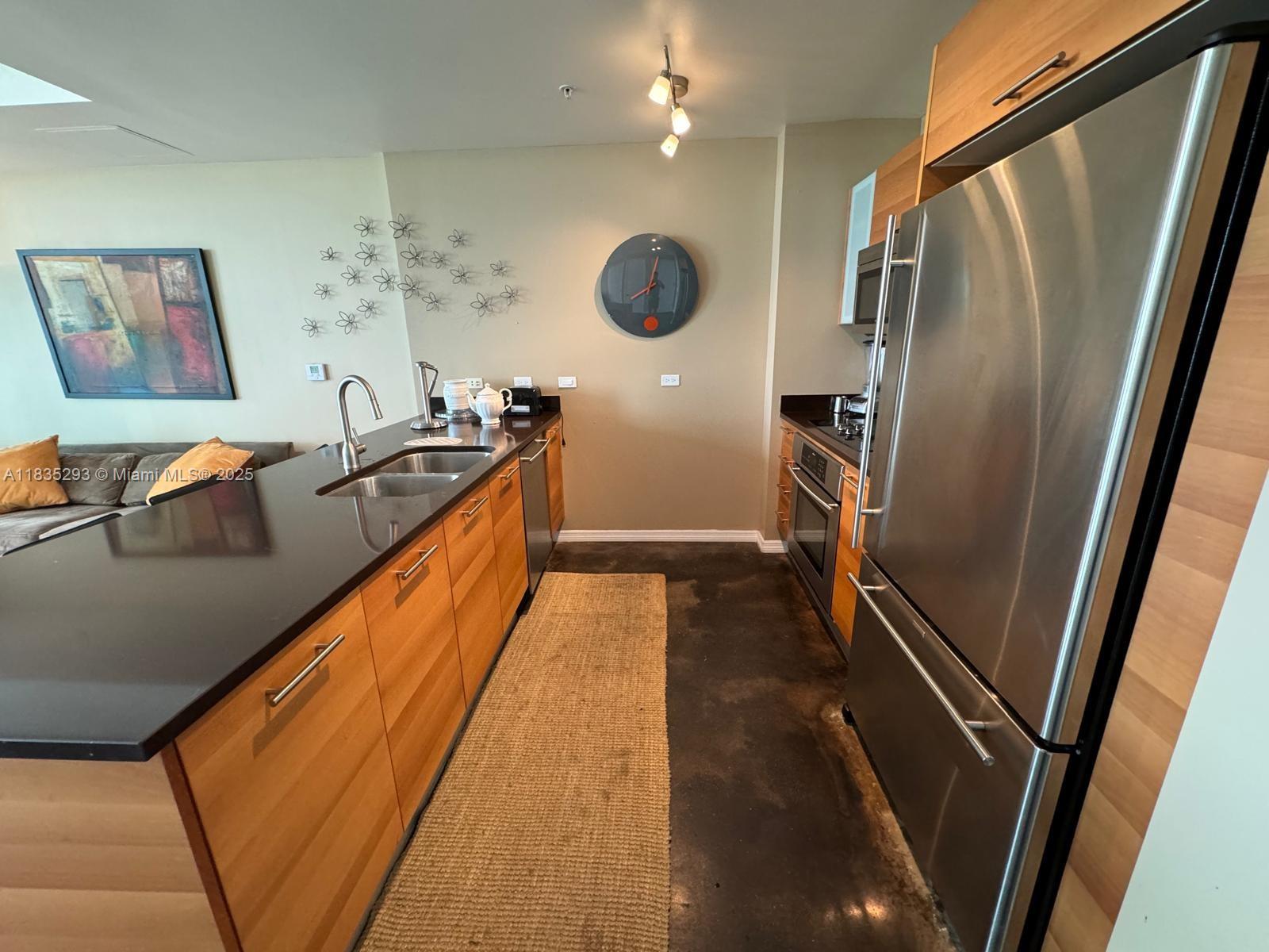 3301 Northeast 1st Avenue, Unit H2903 Miami, FL 33137 - Photo 5 of 20 a kitchen with stainless steel appliances granite countertop a refrigerator and a sink