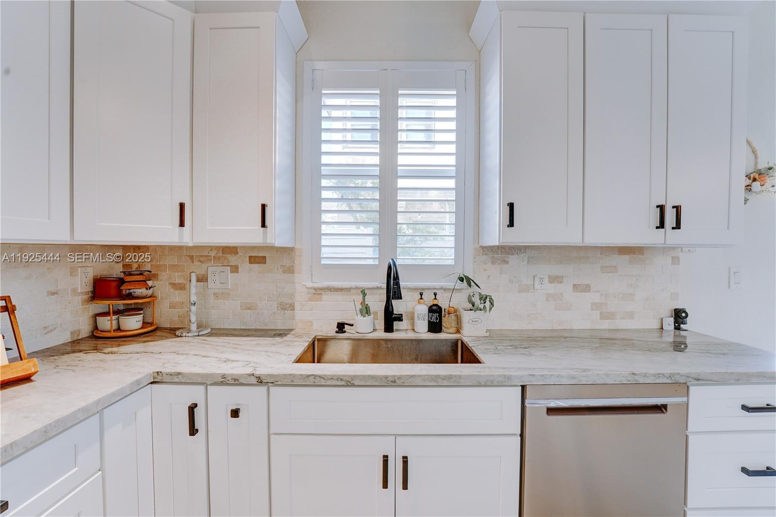 12771 Southwest 133rd Street Miami, FL 33186 - Photo 16 of 39 a kitchen with stainless steel appliances granite countertop white cabinets sink and window