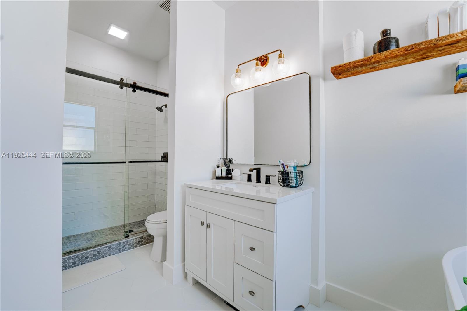 12771 Southwest 133rd Street Miami, FL 33186 - Photo 24 of 39 a bathroom with a sink a toilet and shower