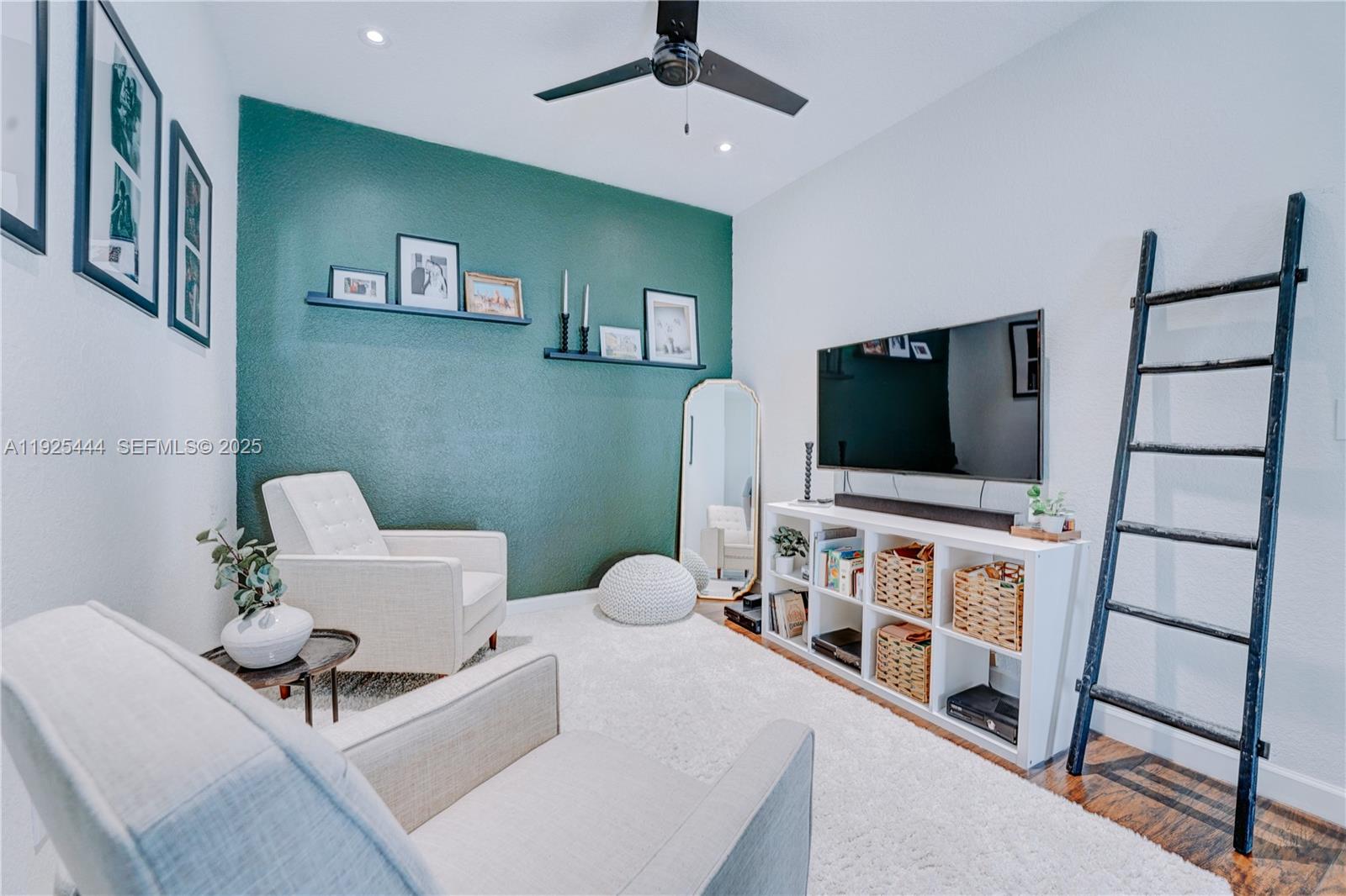 12771 Southwest 133rd Street Miami, FL 33186 - Photo 27 of 39 a living room with furniture and a flat screen tv