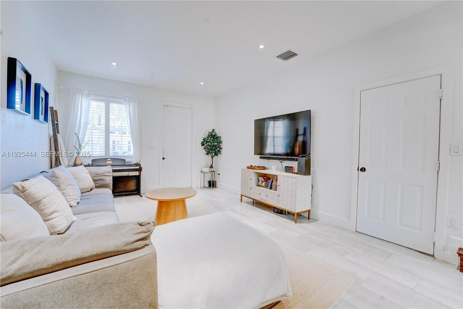 12771 Southwest 133rd Street Miami, FL 33186 - Photo 5 of 39 a living room with furniture and a flat screen tv