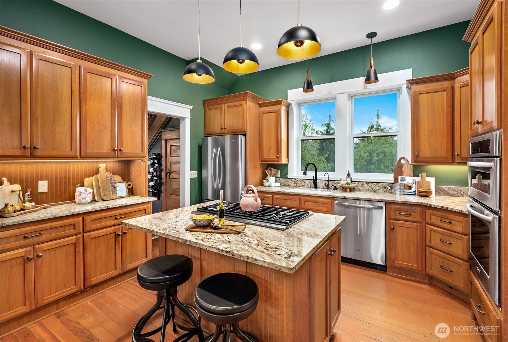 2304 Norman Road Stanwood, WA 98292 - Photo 6 of 39 a kitchen with stainless steel appliances granite countertop a stove a sink dishwasher and cabinets with wooden floor