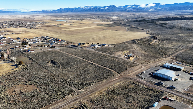 Aerial view of sparsely populated area featuring a mountain backdrop and a desert landscape