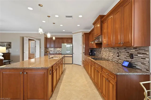 a kitchen with stainless steel appliances granite countertop wooden cabinets a sink and a stove
