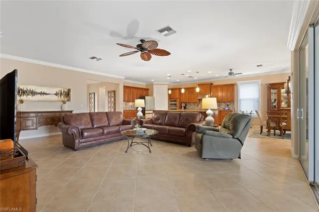 a living room with furniture ceiling fan and a window