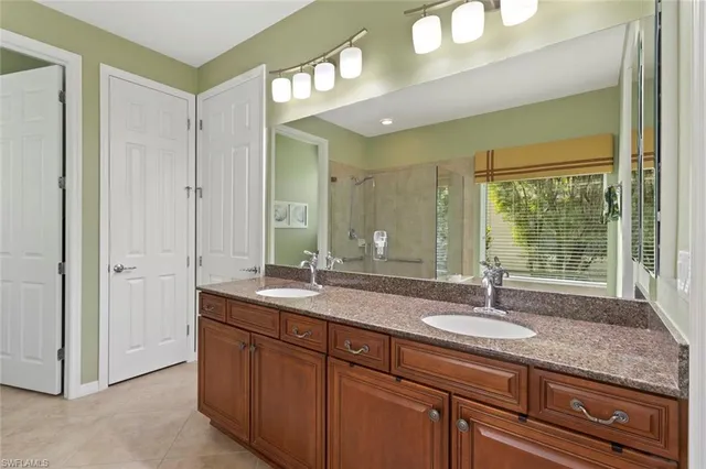 a bathroom with a sink double vanity and a mirror