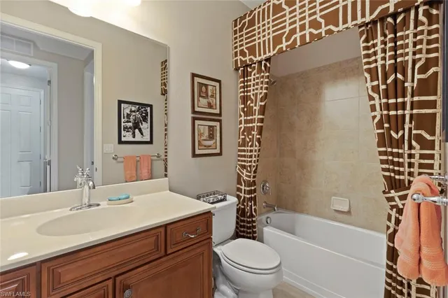 a bathroom with a sink toilet vanity and shower