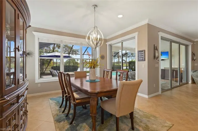 a dining room with furniture a chandelier and wooden floor