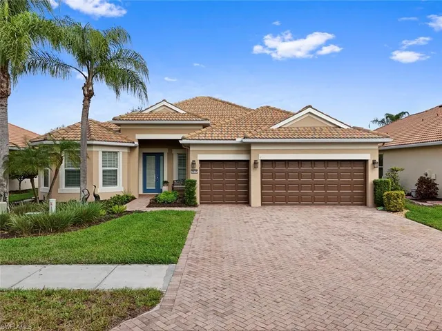 a front view of a house with a garden and yard